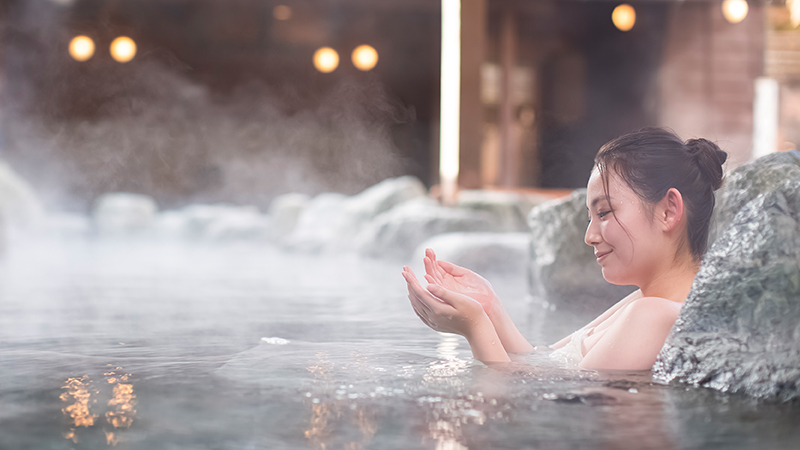 Asian woman pouring nude body with water before the pool